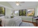 Bright bedroom with three windows, a ceiling fan, and a comfortable bed with neutral bedding at 1195 Oglethorpe Ne Ave, Atlanta, GA 30319