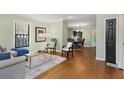 Open-concept living room featuring hardwood floors, neutral walls, and stylish furniture in a well-lit setting at 1195 Oglethorpe Ne Ave, Atlanta, GA 30319