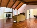Spacious living room with hardwood floors, a stone fireplace, wood beams, and an open floor plan at 3312 Winter Wood Ct, Marietta, GA 30062