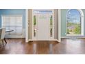 Bright foyer with hardwood floors, decorative glass front door, and a large arched window at 3338 Hackmatack Nw Dr, Kennesaw, GA 30152