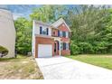 Charming two-story brick home with a well-maintained lawn and attached garage at 6252 Shenfield Ln, Union City, GA 30291
