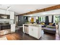 Open-concept living space with modern kitchen island and hardwood floors at 877 Lee Andrews Se Ave, Atlanta, GA 30315