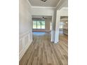 Bright hallway boasts hardwood floors and modern wainscoting, leading to open living spaces at 1715 Crumbley Rd, Mcdonough, GA 30252