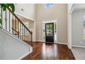 Bright foyer boasts soaring ceilings, wood floors, staircase, and an elegant entry door at 681 Deer Springs Way, Loganville, GA 30052