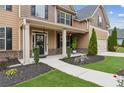 Inviting front porch with manicured landscaping and stylish entrance at 681 Deer Springs Way, Loganville, GA 30052