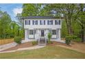 Charming two-story home with a well-maintained front yard and lush landscaping at 3905 Mill Glen Dr, Douglasville, GA 30135