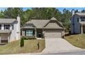 Inviting home with a landscaped front yard, a welcoming entrance, and a convenient two-car garage at 401 Daffodil Dr, Temple, GA 30179
