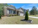 Attractive home with neat landscaping, a two-car garage, and a charming front entrance at 401 Daffodil Dr, Temple, GA 30179