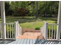 View from the porch stairs of a spacious backyard, offering a serene outdoor space at 5830 Wills Wood Cir, Cumming, GA 30040