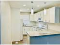Updated kitchen with white cabinets, modern appliances, granite countertops, and recessed lighting at 2961 Stone Mountain St, Lithonia, GA 30058