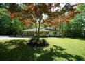 Inviting home with a lush green lawn and mature trees at 343 Ridge Pine Dr, Canton, GA 30114