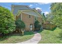 Backyard with a brick exterior and walking path surrounded by lush greenery at 3563 Castleridge Dr, Tucker, GA 30084
