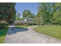 Beautifully landscaped front yard featuring a circular driveway and lush greenery, enhancing the home's appeal at 3563 Castleridge Dr, Tucker, GA 30084