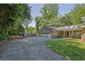 Spacious driveway leads to a large garage, offering ample parking and storage space, surrounded by greenery at 3563 Castleridge Dr, Tucker, GA 30084