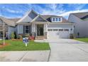 Charming home featuring manicured lawn, stone accents, attached two car garage and inviting entryway at 159 Sunshower Rdg, Canton, GA 30114