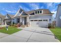Charming home featuring manicured lawn, stone accents, attached two car garage and inviting entryway at 159 Sunshower Rdg, Canton, GA 30114