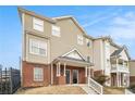 View of two-story townhouse with brick accents and landscaped front yard at 277 Ralph David Abernathy Blvd, Atlanta, GA 30312