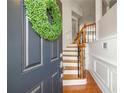 Inviting entryway with wood floors, stairs with rod iron spindles, and a welcoming wreath on the front door at 2827 Overlook Ne Trce, Atlanta, GA 30324