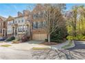 Beautiful townhome with an attached garage, lush landscaping, and mature trees in a serene setting at 2827 Overlook Ne Trce, Atlanta, GA 30324