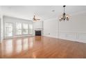 Spacious living room with hardwood floors, fireplace, large windows, and elegant lighting fixtures at 2827 Overlook Ne Trce, Atlanta, GA 30324
