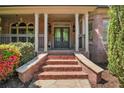 Inviting brick front porch with stately columns and classic double door entry at 4030 Palisades Main Nw, Kennesaw, GA 30144