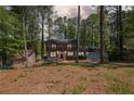 Charming two-story home with a double door garage, nestled in a lush, wooded lot at 4232 Rue Saint Dominique, Stone Mountain, GA 30083