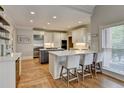 Beautiful kitchen with stainless steel appliances, quartz countertops, and an island with bar seating at 7050 Redcliff Ct, Suwanee, GA 30024