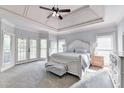 Spacious main bedroom with a trey ceiling, sitting area, and lots of natural light at 7050 Redcliff Ct, Suwanee, GA 30024
