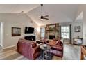 Cozy living room with stone fireplace, vaulted ceilings, and comfortable leather seating at 1132 Owen Cir, Sugar Hill, GA 30518