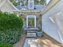 Close-up of the front door featuring stone accents, steps, and a well-manicured entrance at 1017 Fairway Valley Dr, Woodstock, GA 30189