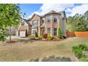 Spacious two-story home with a three-car garage and well-maintained lawn at 1304 Slate Bend Dr, Dacula, GA 30019