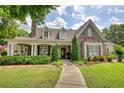 Beautifully landscaped home with stone accents, covered porch, and inviting curb appeal at 3818 Bay Forest Way, Loganville, GA 30052