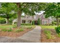 Charming home with lush greenery, inviting walkway, and stone accents at 3818 Bay Forest Way, Loganville, GA 30052