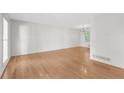 Bright living room featuring hardwood floors and a large window providing natural light at 46 Hawkins Store Nw Rd, Kennesaw, GA 30144