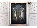 Close-up of a decorative front door with intricate ironwork at 6687 Hill Creek Cv, Lithonia, GA 30058