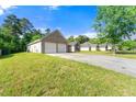 Property featuring a two-car garage and ample driveway space at 6687 Hill Creek Cv, Lithonia, GA 30058