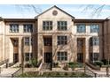 Attractive townhome complex featuring well-maintained landscaping, stately entrances, and brick staircases at 3475 Oak Valley Rd # 130, Atlanta, GA 30326