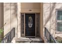 Charming black front door with decorative glass panels, enhanced by elegant sidelights and hardware at 3475 Oak Valley Rd # 130, Atlanta, GA 30326