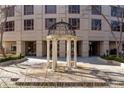 The gazebo in the community area is framed by a stylish building featuring elegant architectural details at 3475 Oak Valley Rd # 130, Atlanta, GA 30326