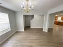 Bright living room features lovely laminate floors, neutral paint, and lots of natural light at 4884 Browns Mill Ferry Rd, Lithonia, GA 30038