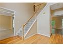 View of foyer featuring a hardwood floor, staircase with white banister, and views into other rooms at 861 Southland Pass, Stone Mountain, GA 30087