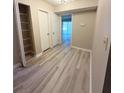 Hallway with wood-look floors, coat closet, and easy access to other rooms at 296 Country Club Dr, Jonesboro, GA 30238