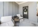 Cozy front porch featuring comfortable seating and a wreath on the front door at 3020 Westgate Park Dr, Loganville, GA 30052