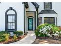 Close up of the home's entrance featuring a blue door, beautiful shrubbery, and an inviting walkway at 4161 Sherwood Oaks Dr, Decatur, GA 30034