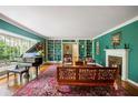 Bright living room with hardwood floors, custom built-ins, and a cozy fireplace at 705 W Ponce De Leon Ave, Decatur, GA 30030