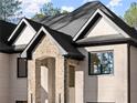 Close-up of a home's architectural details including stone accents, arches, brick, and dark trimmed windows at 1540 Brooks S Rd, Lawrenceville, GA 30045