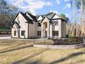 Elegant two-story home showcases beautiful brick and stone masonry with a well manicured lawn and wrought iron fencing at 1540 Brooks S Rd, Lawrenceville, GA 30045