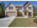 Beautiful two-story home with brick and siding, featuring a well-kept lawn, attached garage, and mature trees at 1993 Side Branch Way, Lawrenceville, GA 30045