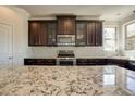 Modern kitchen with granite countertops, stainless steel appliances, and custom cabinetry at 1993 Side Branch Way, Lawrenceville, GA 30045