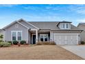 Attractive single-Gathering home with a two-car garage, complemented by well-maintained landscaping and a clear sky at 242 Cordova St, Woodstock, GA 30189